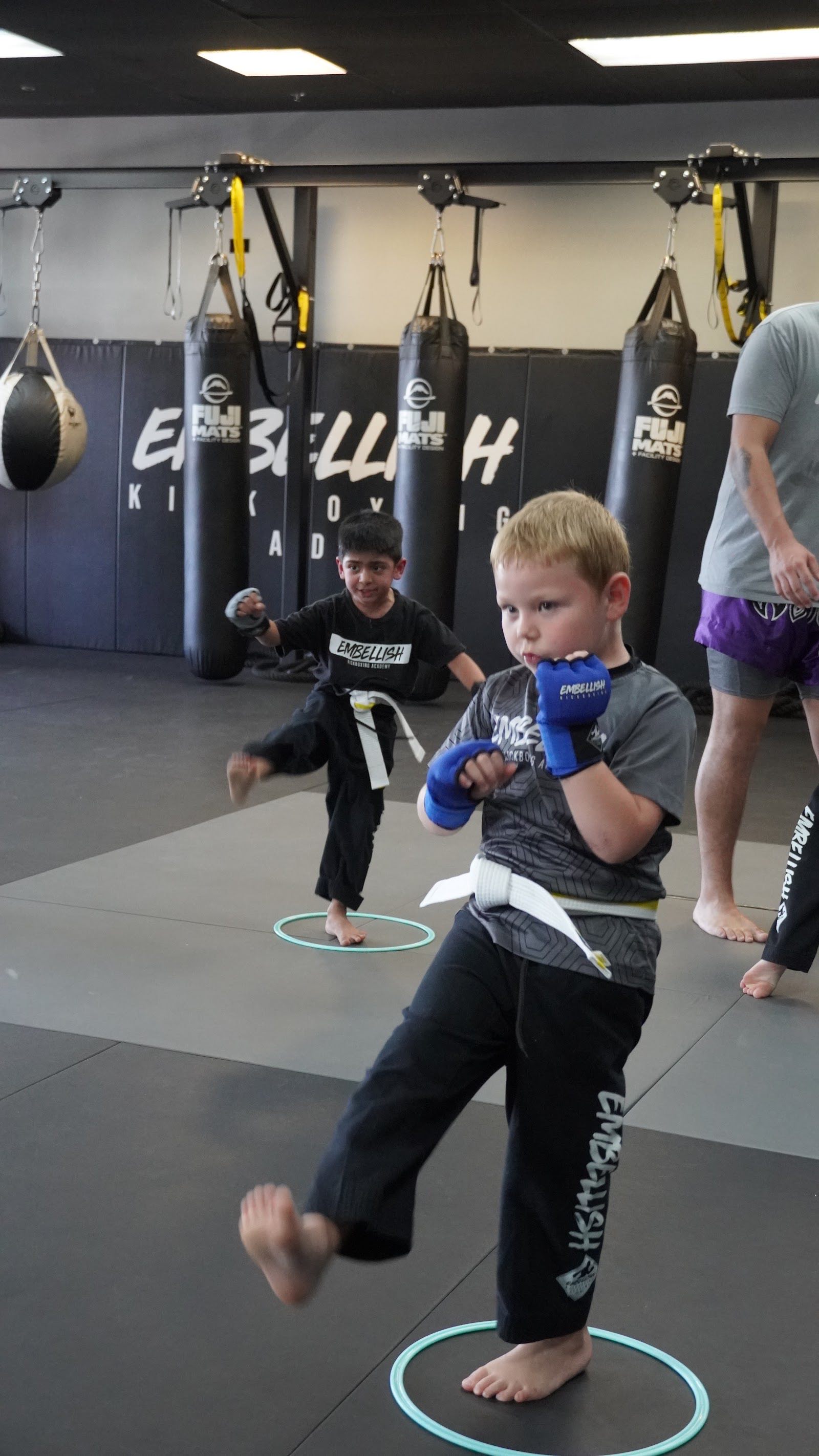 Mini Titans students practicing stance and technique at Embellish Kickboxing Academy in Elk Grove.